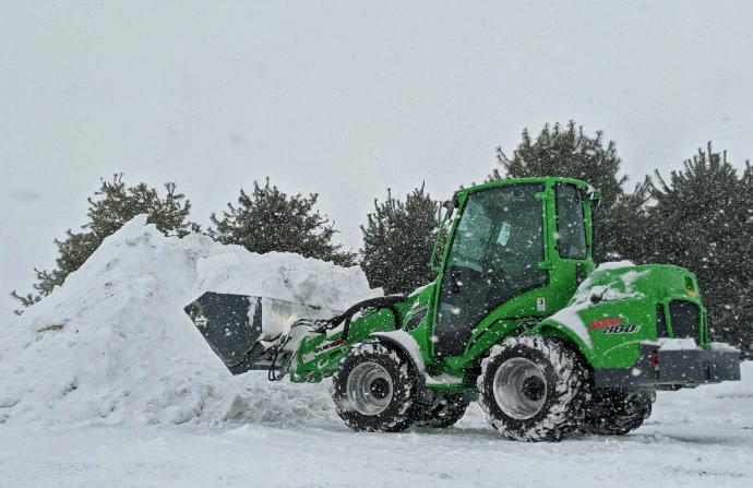 green and black atv on snow covered ground